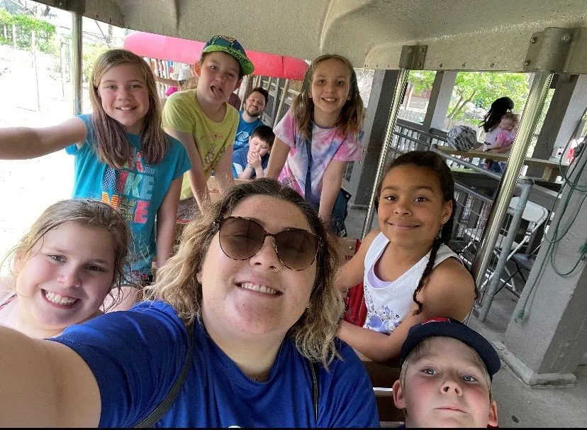 BGCStory staff member selfie with several kids