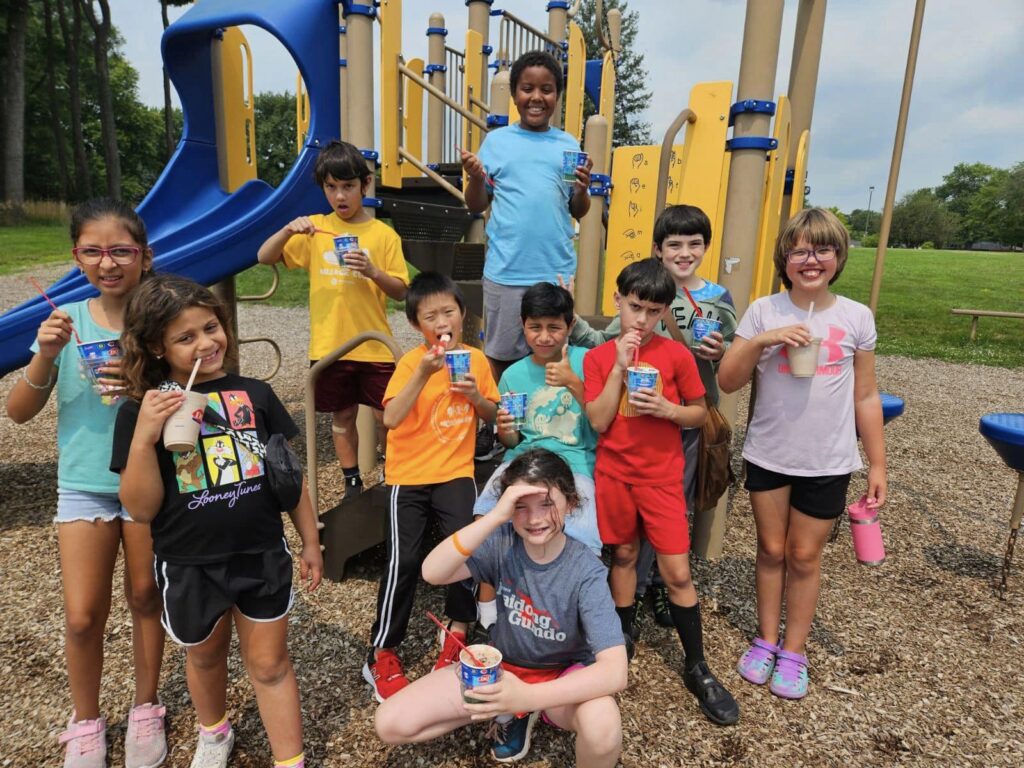 Kids standing in a playground with various treats from Dairy Queen