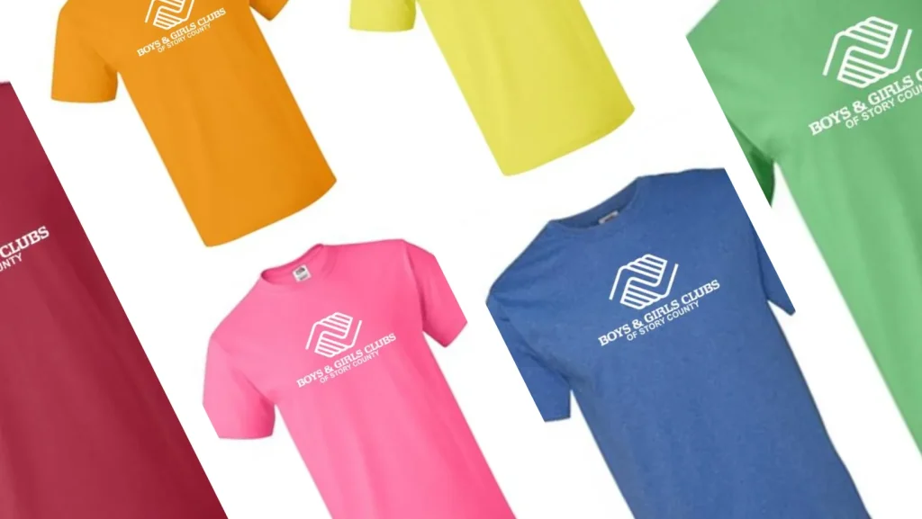 Several shirts with the BGC of Story County logo on them in green, yellow, blue, orange, pink, and red.