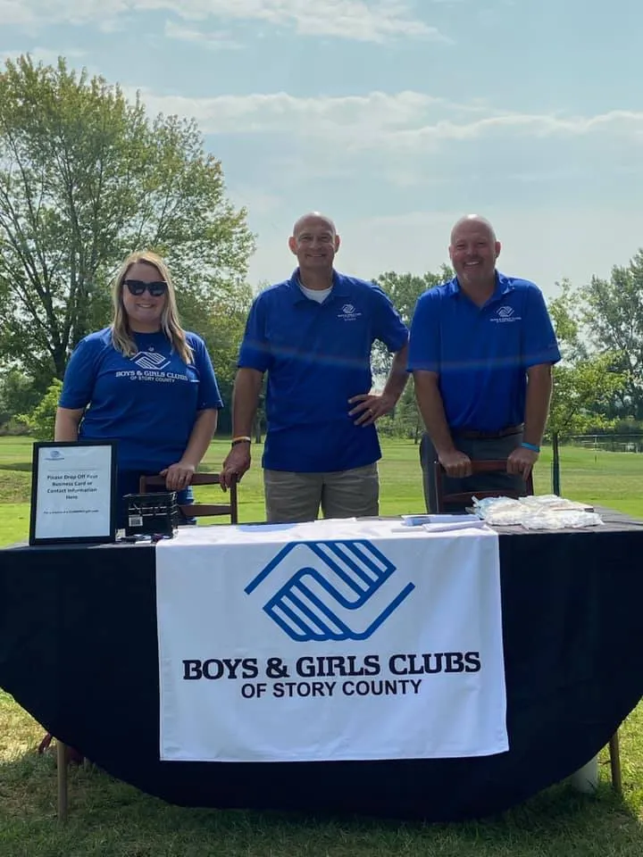 BGCStory staff members standing at a booth at the Golf event