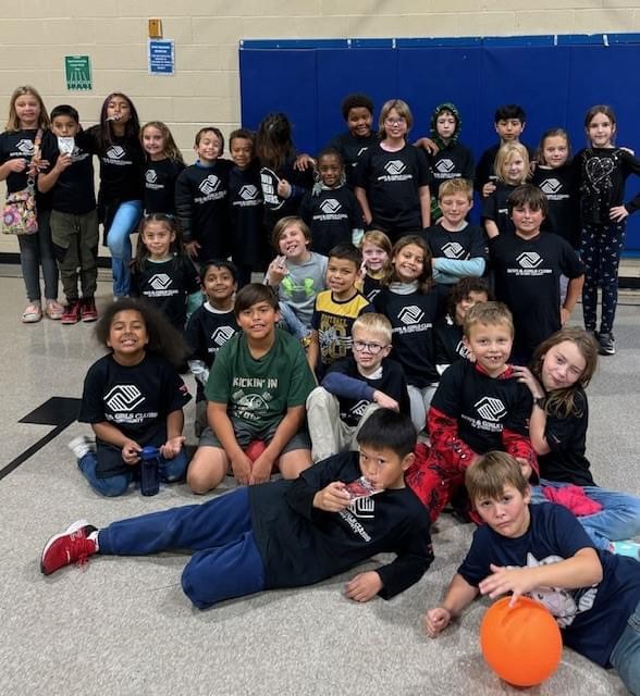 Kids posing in black BGC Story t-shirts